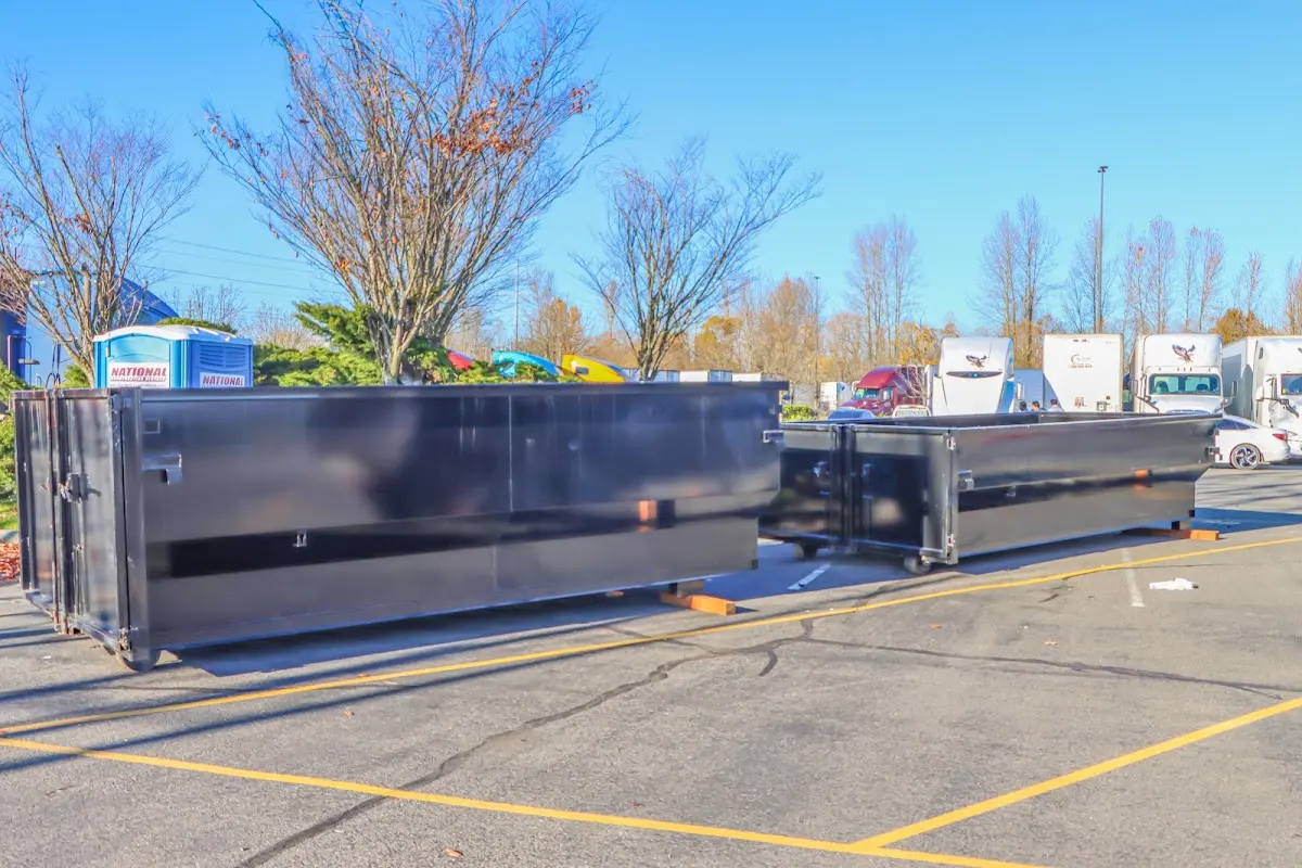 Professional dumpster rental service with roll-off container on residential driveway in Spring Grove